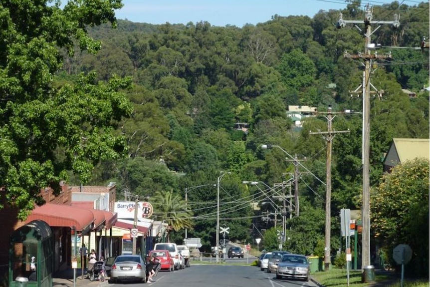 A small town surrounded by forested hills.