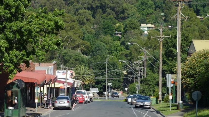 A small town surrounded by forested hills.