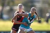 Olivia Levicki competes for the ball with an Essendon player.