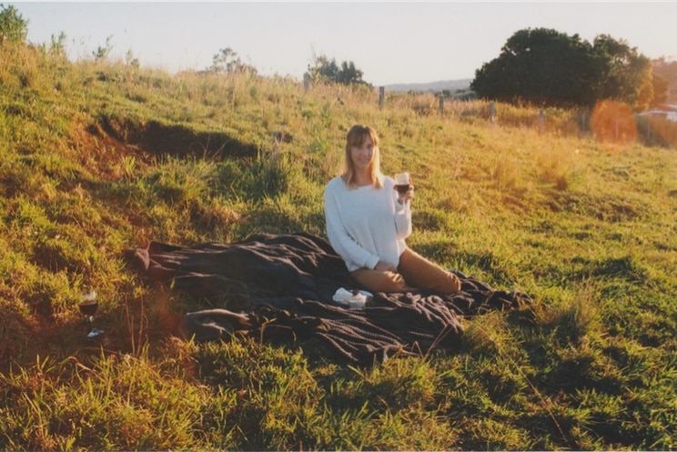 Nicolle White from the ABC enjoying a picnic with wine and a blanket, post deleting Instagram