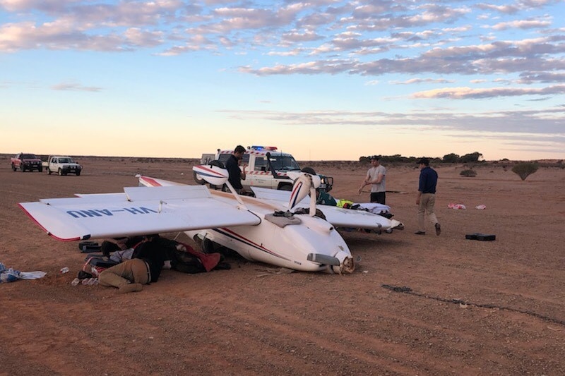 people tend to the injured at the plane crash
