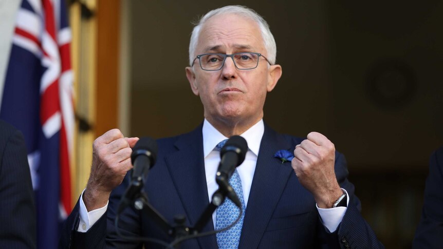 Prime Minister Malcolm Turnbull holds two fists up as he speaks at Parliament House.