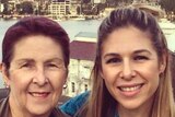 A mother and daughter-selfie with Sydney Harbour in the background