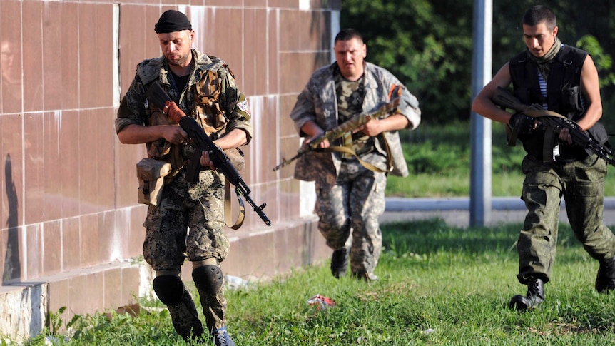 Pro-Russian militants run near their checkpoint in the eastern Ukrainian city of Slaviansk.