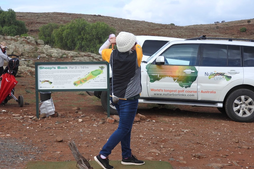 Women golfer tees off on Nullarbor Links golf course.