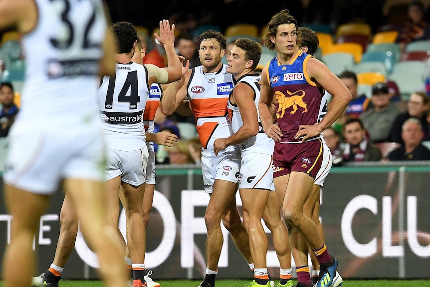 Giants players celebrate a goal against Brisbane Lions at the Gabba on June 23, 2018.