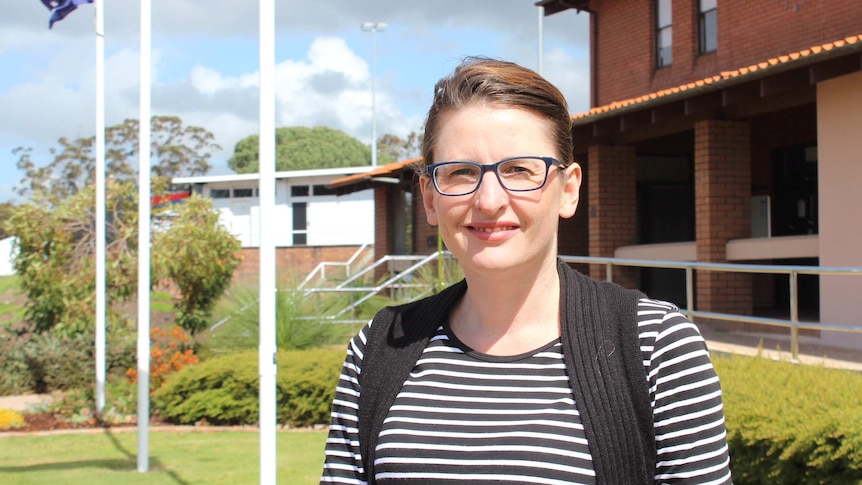 Collie Shire President Sarah Stanley outside the shire offices, with flagpoles in the background.
