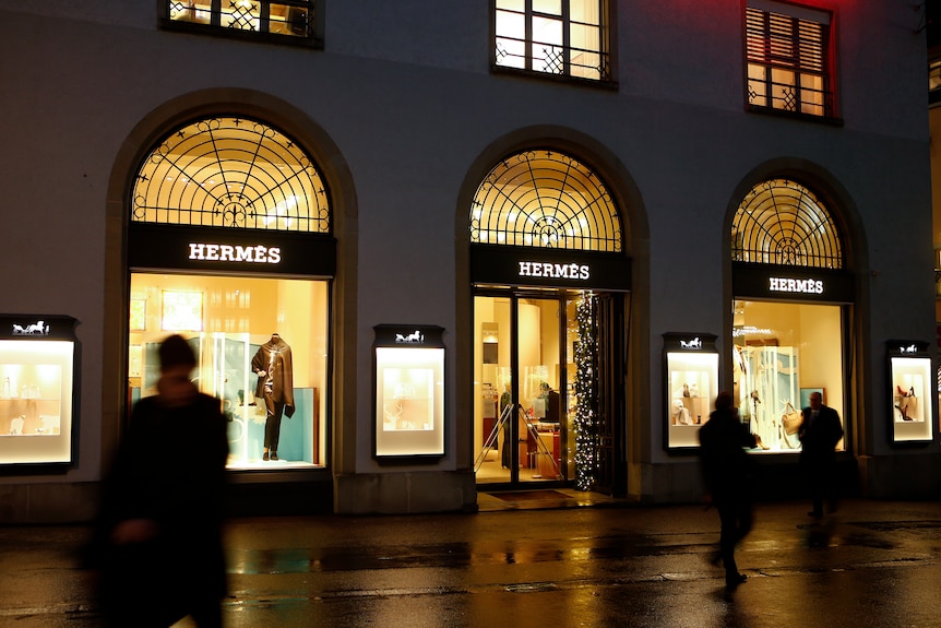 A Hermes storefront at night 