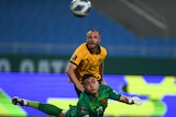 Rhyan Grant watches as the ball sails past the Vietnamese goalkeeper, who is diving backwards and looking at the ball