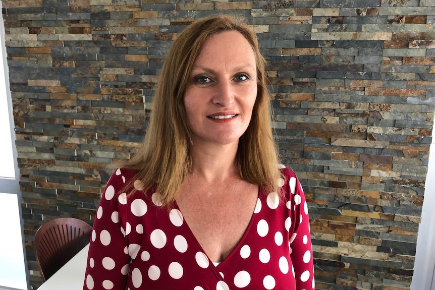 woman in red and white polka dot dress smiling