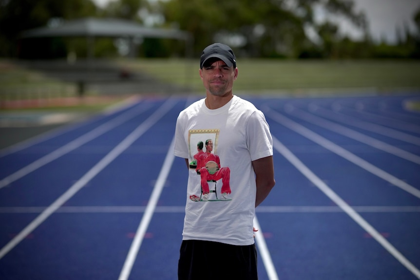 Matthew Centrowitz standing in the middle of a running race track 