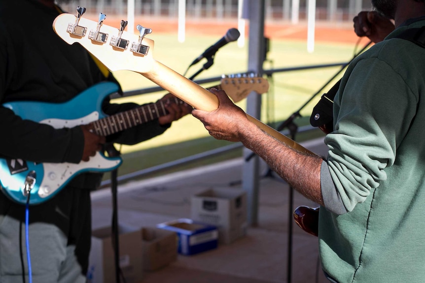 Bass and rhythm guitar players at the 2017 NAIDOC prison battle of the bands.