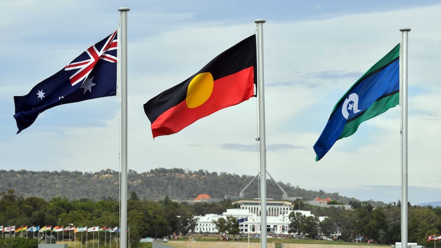 The Australian, Aboriginal and Torres Strait flags fly in Canberra.