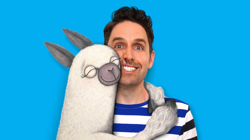 The author being hugged by one of his illustrated alpacas.