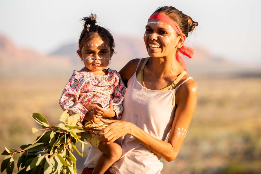 A woman holding a little girl.