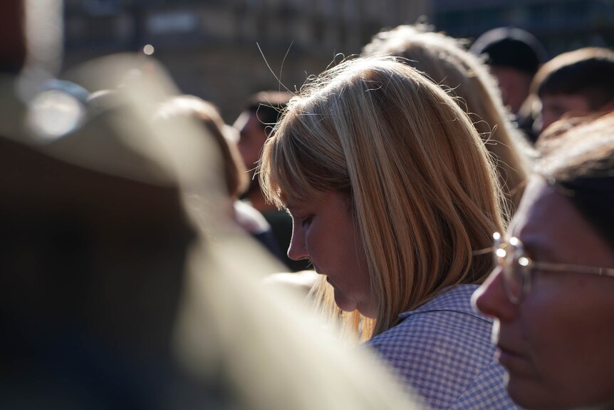 A woman says the Lords Prayer as she listens to a mass commemorating Queen Elizabeth.
