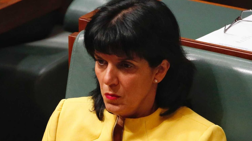 Liberal member for Chisholm Julia Banks sits in the house of reps, wearing a yellow blazer