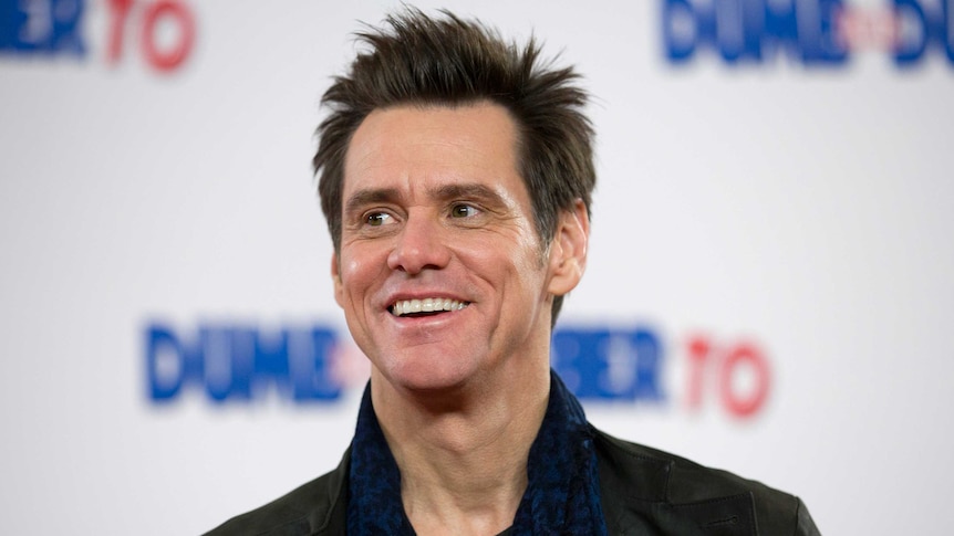 US actor Jim Carrey poses for photographers at a photocall for the film "Dumb and Dumber to" in London.