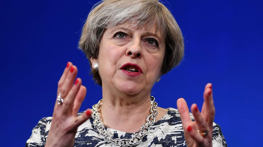 Britain's Prime Minister Theresa May speaks with her hands raised during a campaign visit.