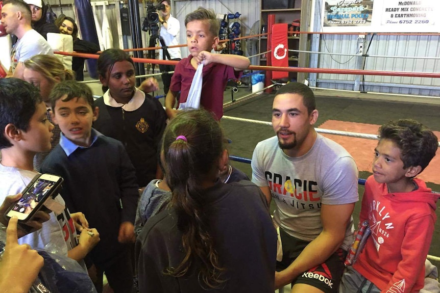 Whittaker surrounded by kids.