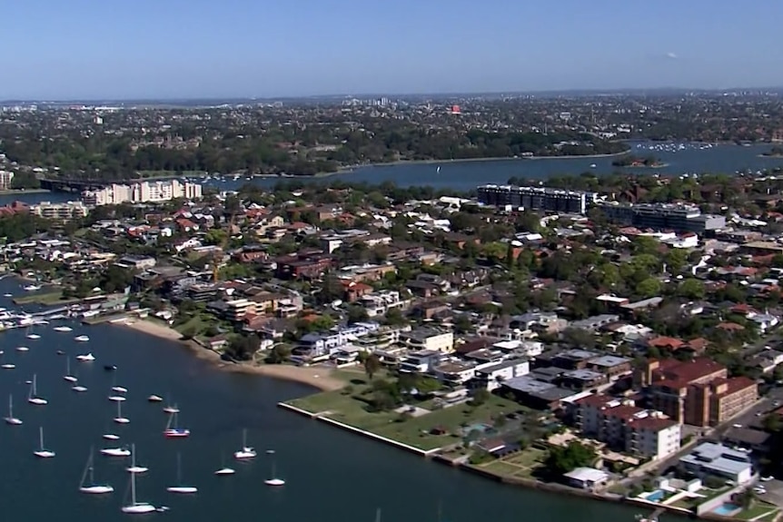 Aerial of suburban housing along the Parramatta River. 