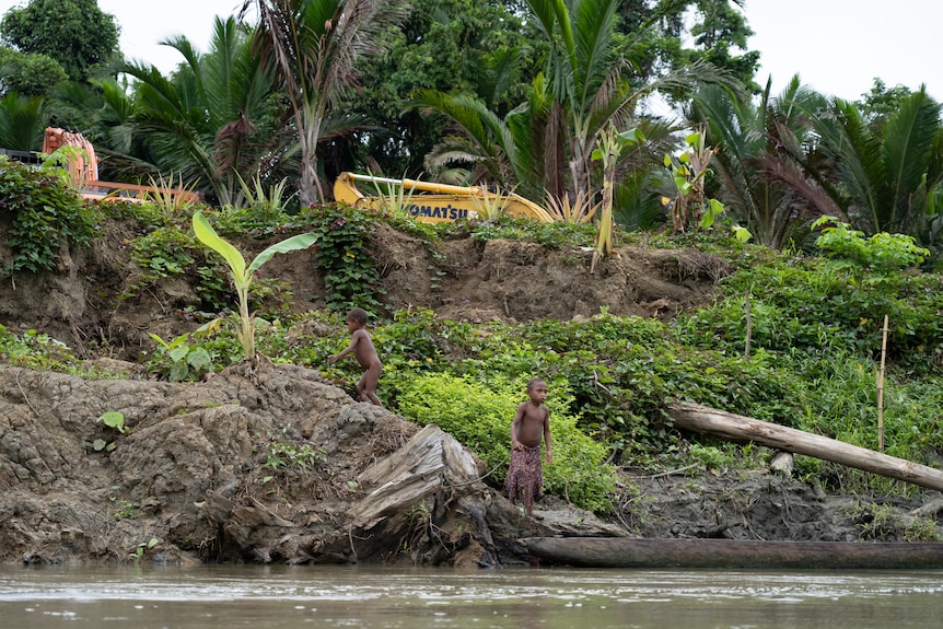 Children play on the riverbank.