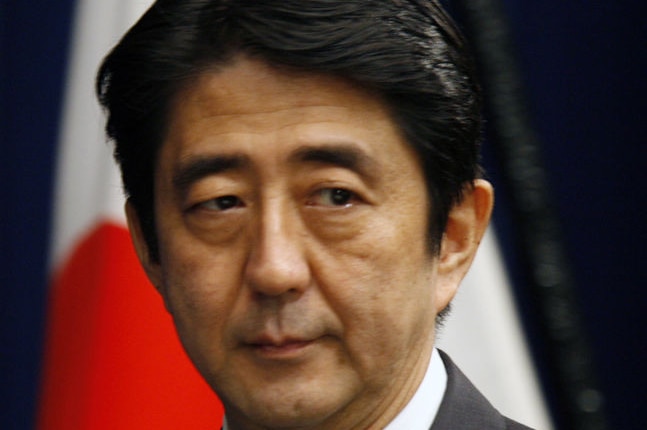 Shinzo Abe is seen looking gloomy.