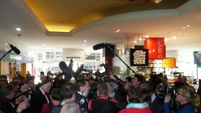 A media scrum follows Prime Minister Julia Gillard as she visits Eastland shopping centre in Melbourne