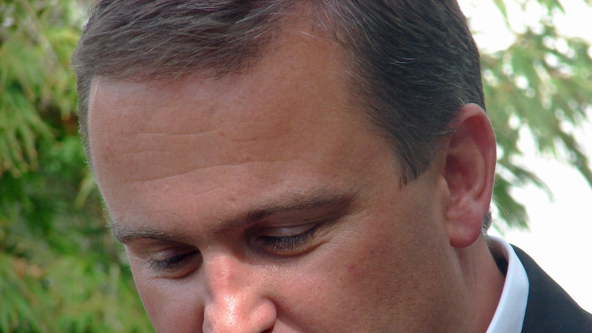 Tasmanian premier David Bartlett looks down at a  media conference about his resignation.