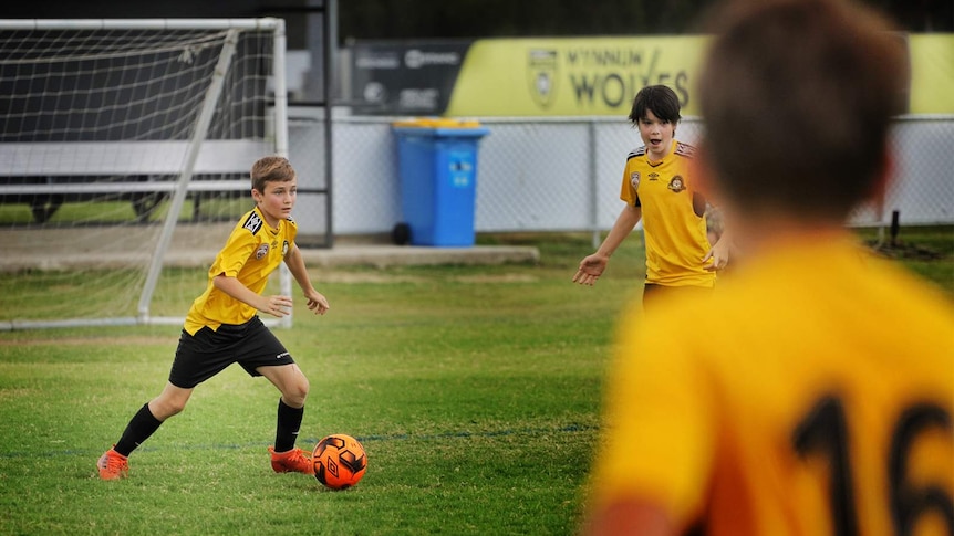 12-year-old in uniform with the soccer ball.