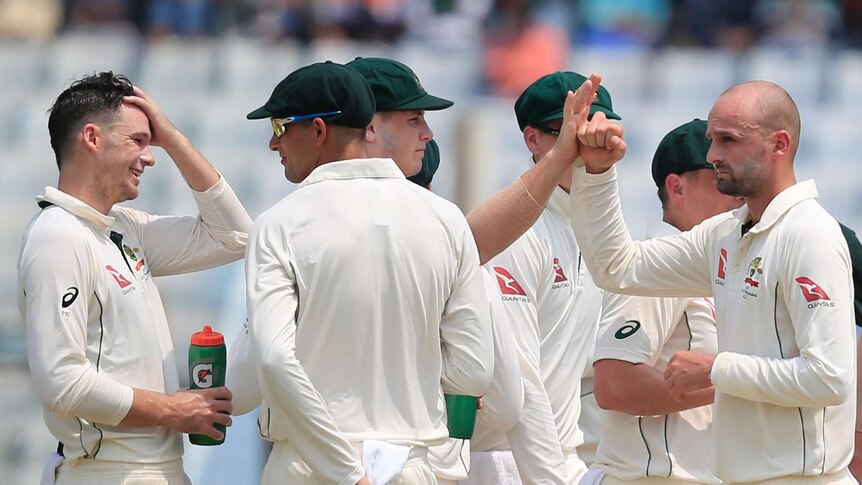 Australia's Nathan Lyon celebrates with team-mates after dismissing Bangladesh's Imrul Kayes