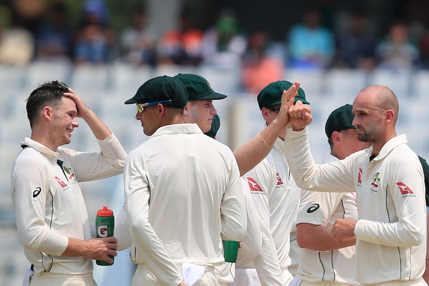 Australia's Nathan Lyon celebrates with team-mates after dismissing Bangladesh's Imrul Kayes