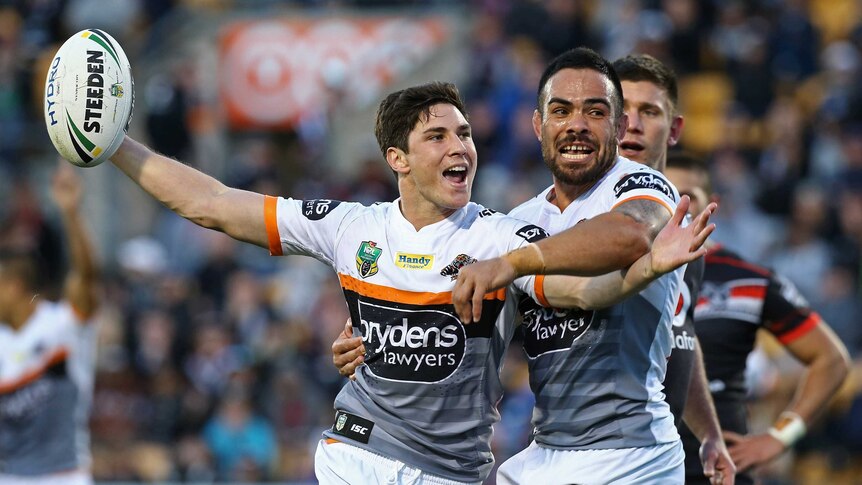Wests Tigers' Mitchell Moses (L), celebrates with Dene Halatau against the Warriors in Auckland.