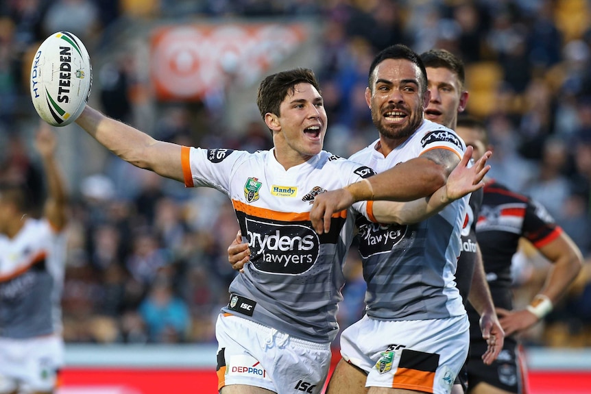 Mitchell Moses and Dene Halatau celebrate against the Warriors