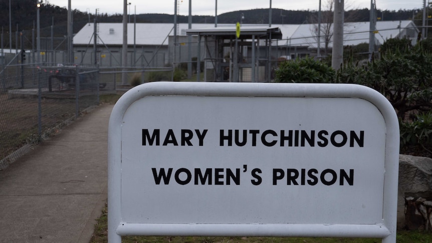 A sign outside a tall fence that says Mary Hutchinson Women's Prison