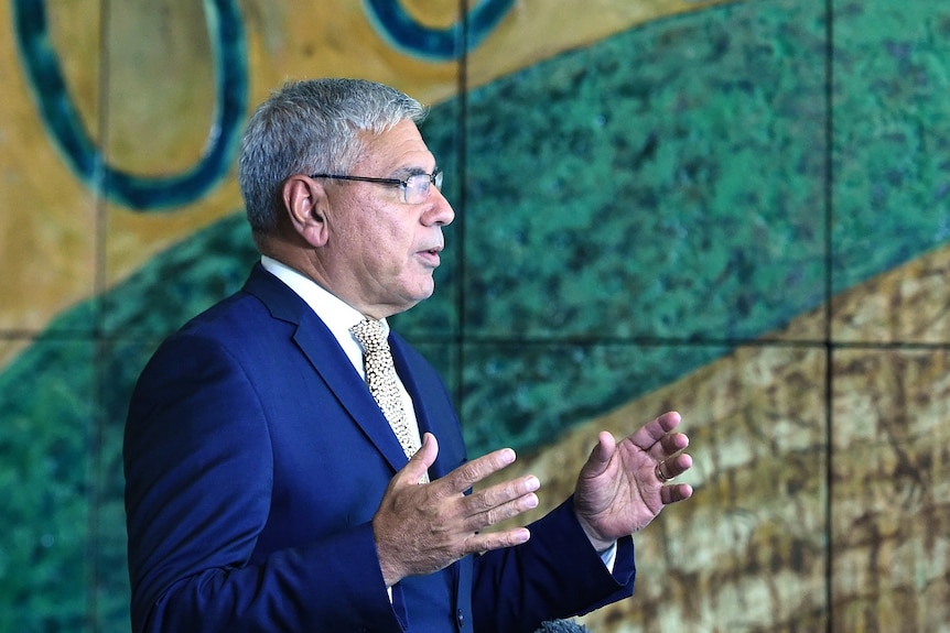 A side profile of Australian Aboriginal leader Warren Mundine speaking at a press conference.