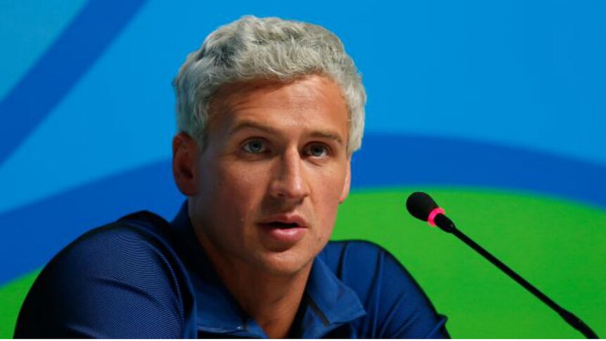 Ryan Lochte speaks into a microphone during a press conference at the Rio Games. Photo: Getty Images