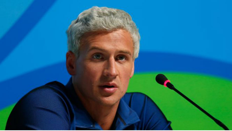Ryan Lochte speaks into a microphone during a press conference at the Rio Games. Photo: Getty Images