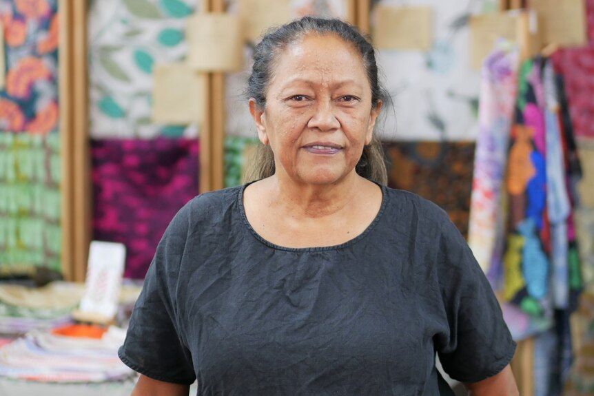 Eunice Yu stands in front of textiles in Nagula Jarndu 