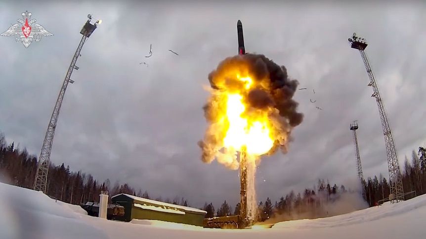 Flames shoot from beneath a ballistic missile launched from an air field during military drills. 