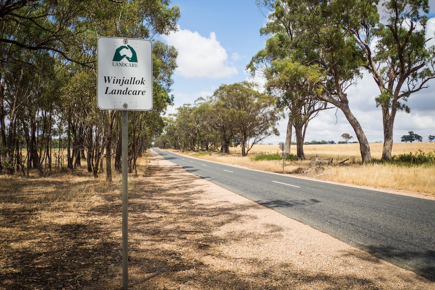 a sign acknowledging Winjallok Landcare by the side of a sealed country road
