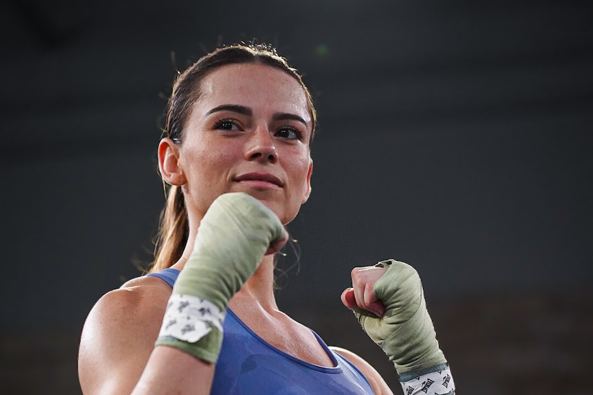 A female boxer holds up her fists