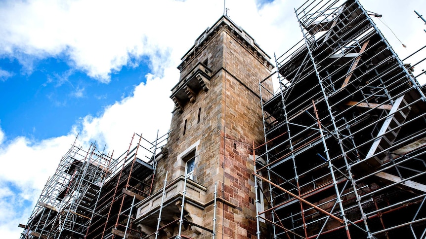 The Marble Hill tower covered by scaffolding.