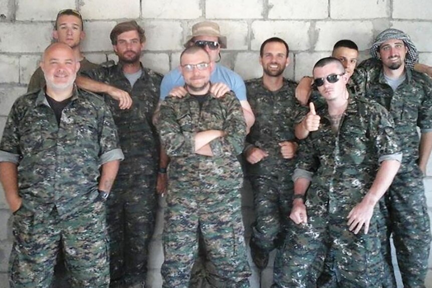 Fighting with the Kurdish militia group YPG: Ashley Dyball (front right) and American Mike Fonda (front centre) with fellow fighters. Gold Coast man Reece Harding, second from left at rear, was killed in July.