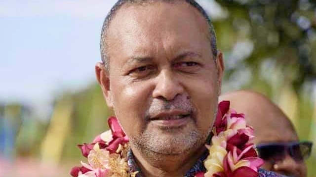 Sam Basil with a bright lei around his neck. 