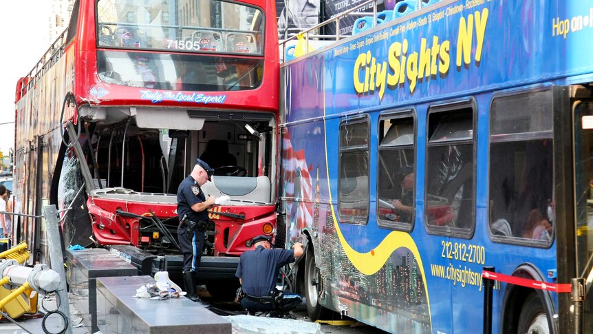 Police inspect two buses that collided in Times Square