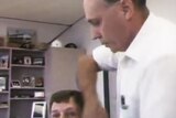 CLP minister Max Ortmann wraps a microphone cable around ABC journalist Jeremy Thompson's neck in 1993.