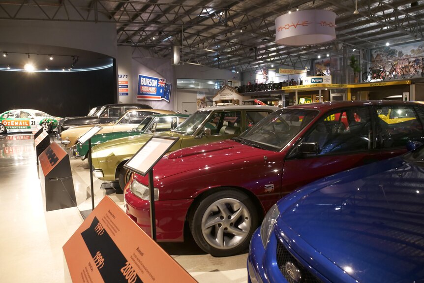 A close up of a range of classic cars in a car museum 