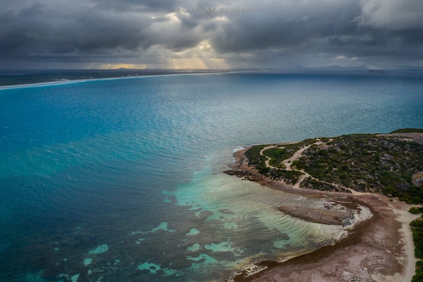 An aerial view of a beach at dawn taken by a drone.