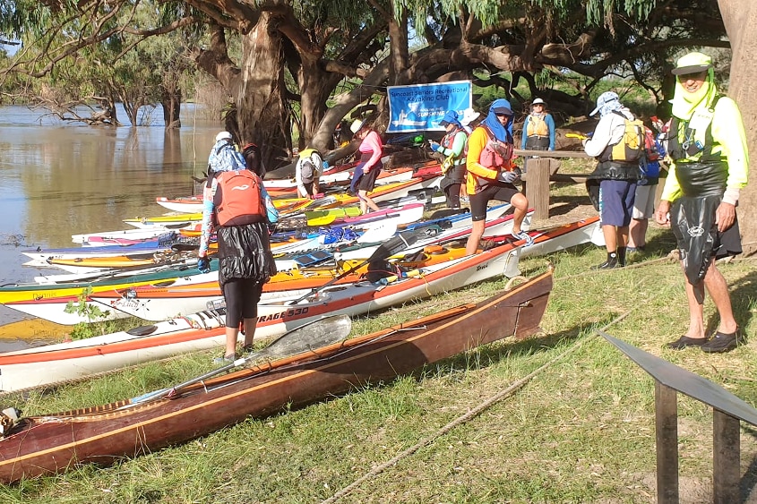 Kayaks on a river bank